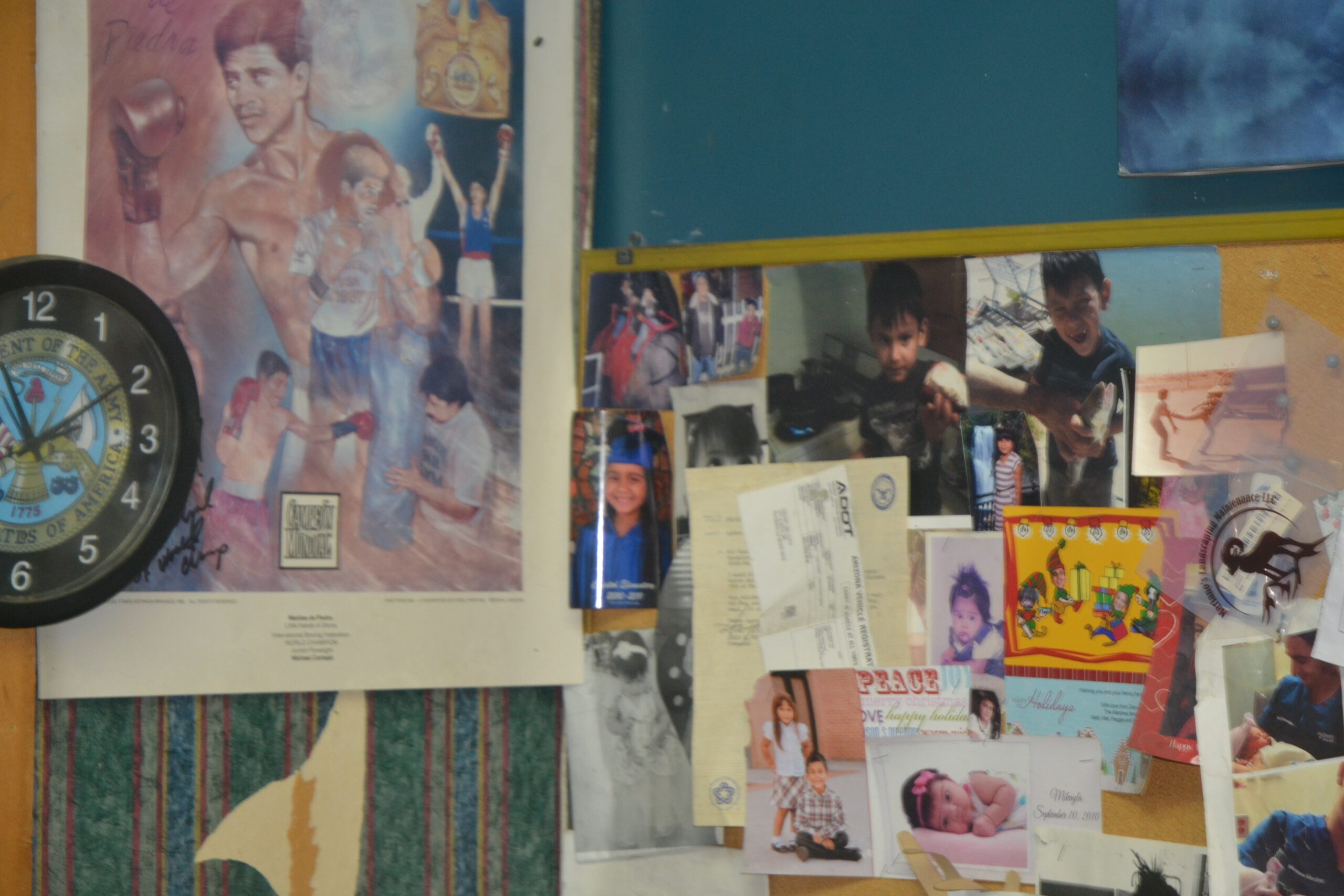 Wall display inside Phoenix Custom Tees showing local shop history, photos, and creative print shop details.<br />

